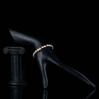 Side angle view of KHAISTA gold plated designer tennis bracelet