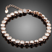 KHAISTA gold plated designer tennis bracelet on white background