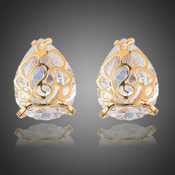 KHAISTA gold plated flower shaped CZ earrings on white background