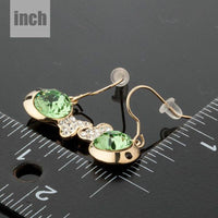 gold plated green crystal fish drop earrings detail view by KHAISTA