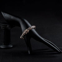 Side angle view of KHAISTA gold plated jaguar print bangle