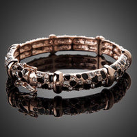 Close up detail of KHAISTA gold plated jaguar print bangle
