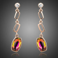 KHAISTA gold plated curved crystal drop earrings on white background