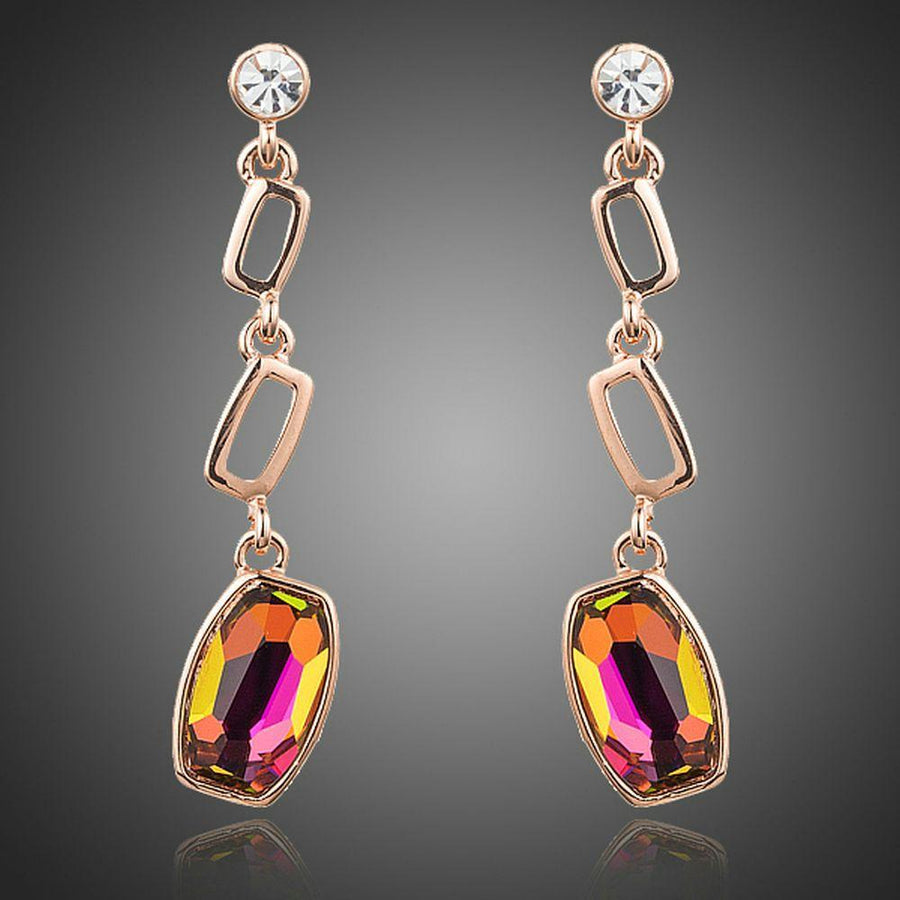 KHAISTA gold plated curved crystal drop earrings on white background
