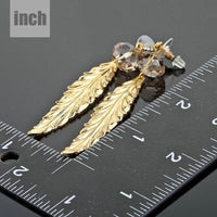 gold plated leaf drop earrings detail view by KHAISTA