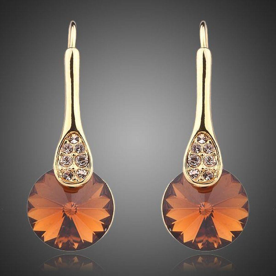 KHAISTA gold plated maple leaf design drop earrings on white background