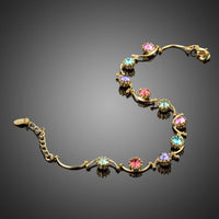 Side angle view of KHAISTA gold plated crystal cluster bracelet