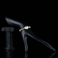 Side angle view of KHAISTA gold plated oval crystal bracelet