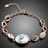 KHAISTA gold plated oval crystal bracelet on white background
