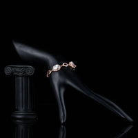 Side angle view of KHAISTA gold plated oval CZ bracelet