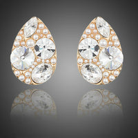 KHAISTA gold plated pear cut stud earrings on white background