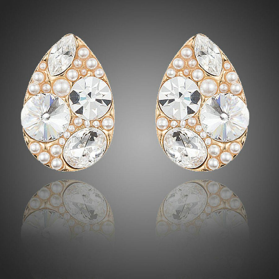 KHAISTA gold plated pear cut stud earrings on white background