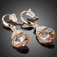 Close up of KHAISTA gold plated raindrop crystal drop earrings