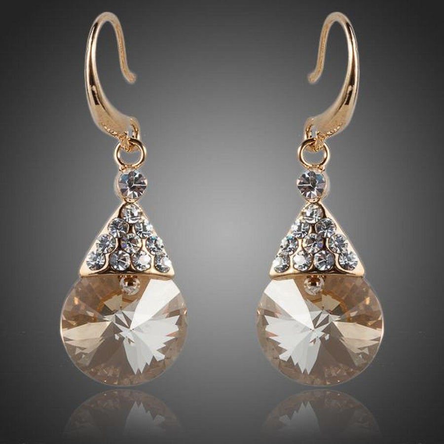KHAISTA gold plated raindrop crystal drop earrings on white background