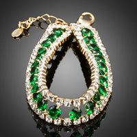 Close up detail of KHAISTA gold plated round green crystal bracelet