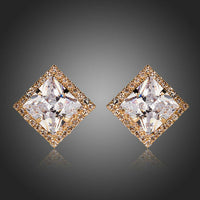 KHAISTA gold plated square CZ stud earrings on white background