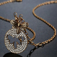 Pendant detail on KHAISTA gold crystal bee pendant necklace
