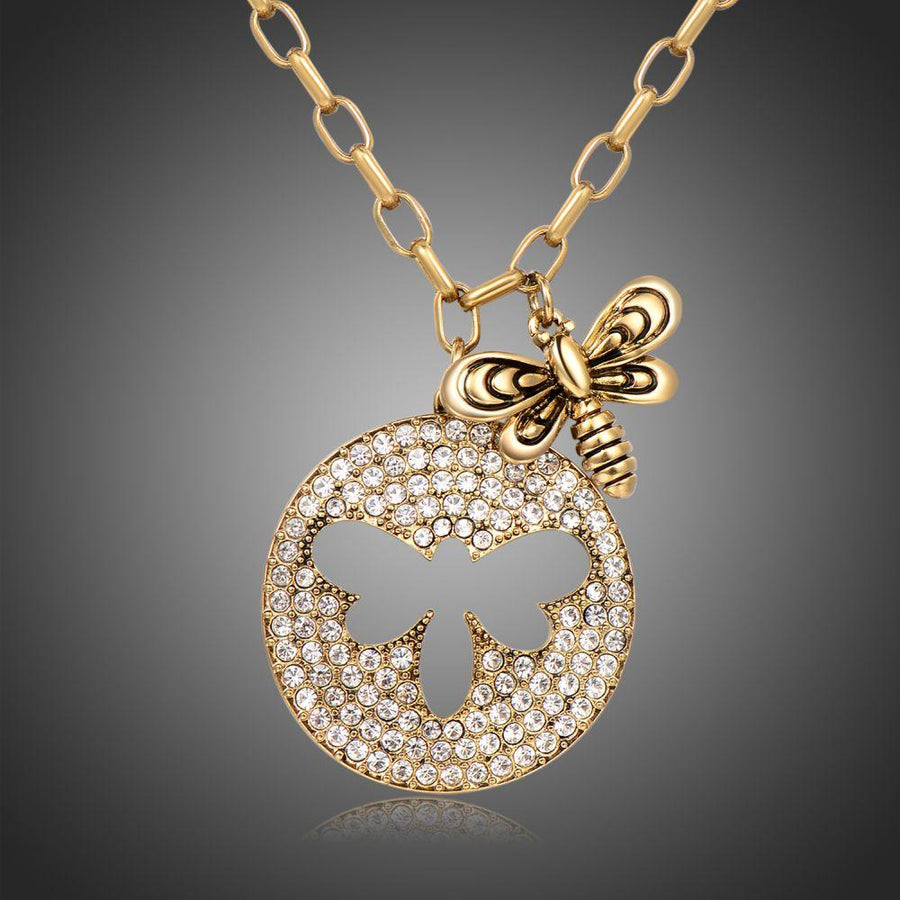 KHAISTA gold crystal bee pendant necklace on white background