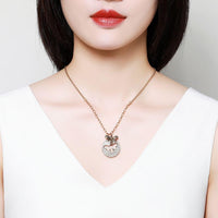 Side angle view of KHAISTA gold crystal bee pendant necklace