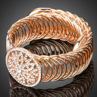 Side angle view of KHAISTA gold crystal hollow circle bangle