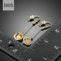 golden CZ drop earrings detail view by KHAISTA