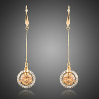 KHAISTA golden CZ drop earrings on white background