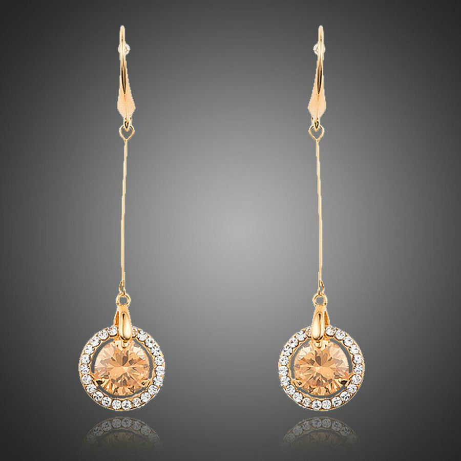 KHAISTA golden CZ drop earrings on white background
