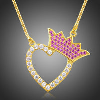 Close up detail of KHAISTA gold heart crown CZ pendant necklace