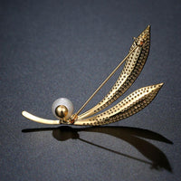 Side angle view of Khaista gold leaf branch brooch