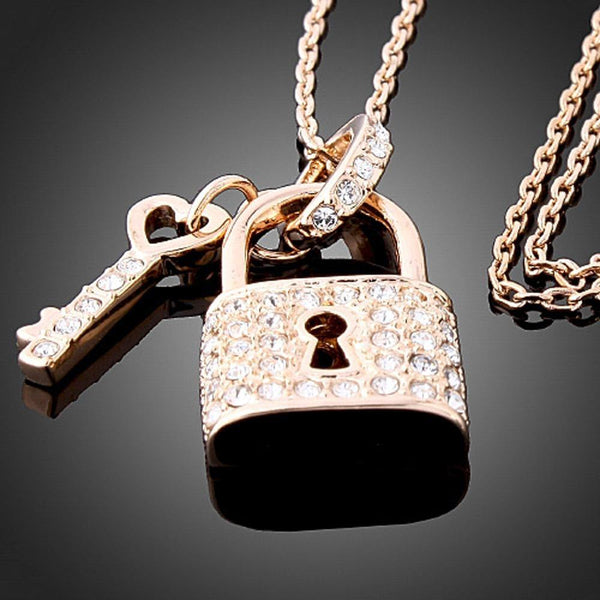 KHAISTA gold padlock love key pendant necklace on white background
