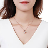 Side angle view of KHAISTA gold paved clear CZ necklace