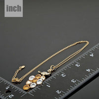 Pendant detail on KHAISTA gold crystal peacock train pendant necklace