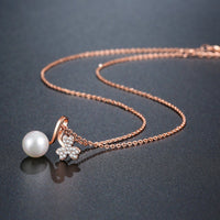 Pendant detail on KHAISTA gold pearl pendant necklace