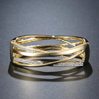 Side angle view of KHAISTA gold reflexions crystal bangle