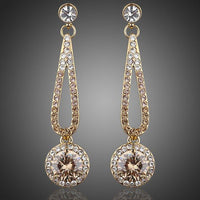 KHAISTA golden round CZ drop earrings on white background