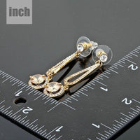 golden round CZ drop earrings detail view by KHAISTA