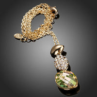 Side angle view of KHAISTA gold crystal sensation pendant necklace