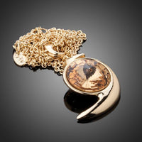 Close up detail of KHAISTA gold crystal snail link chain necklace