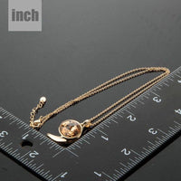 Pendant detail on KHAISTA gold crystal snail link chain necklace