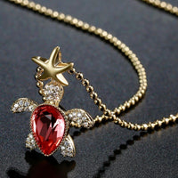 Pendant detail on KHAISTA gold crystal tortoise pendant necklace