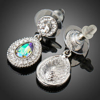 Side angle view of KHAISTA gradual change crystal drop earrings