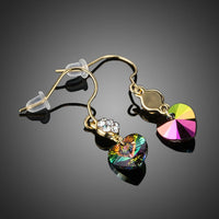 Side angle view of KHAISTA gradual change Stellux heart drop earrings