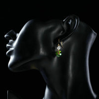 Close up of KHAISTA gradual change Stellux heart drop earrings