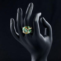 Side angle view of Khaista green crown oil paint ring