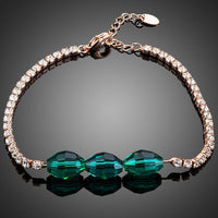 KHAISTA green crystal link chain bracelet on white background