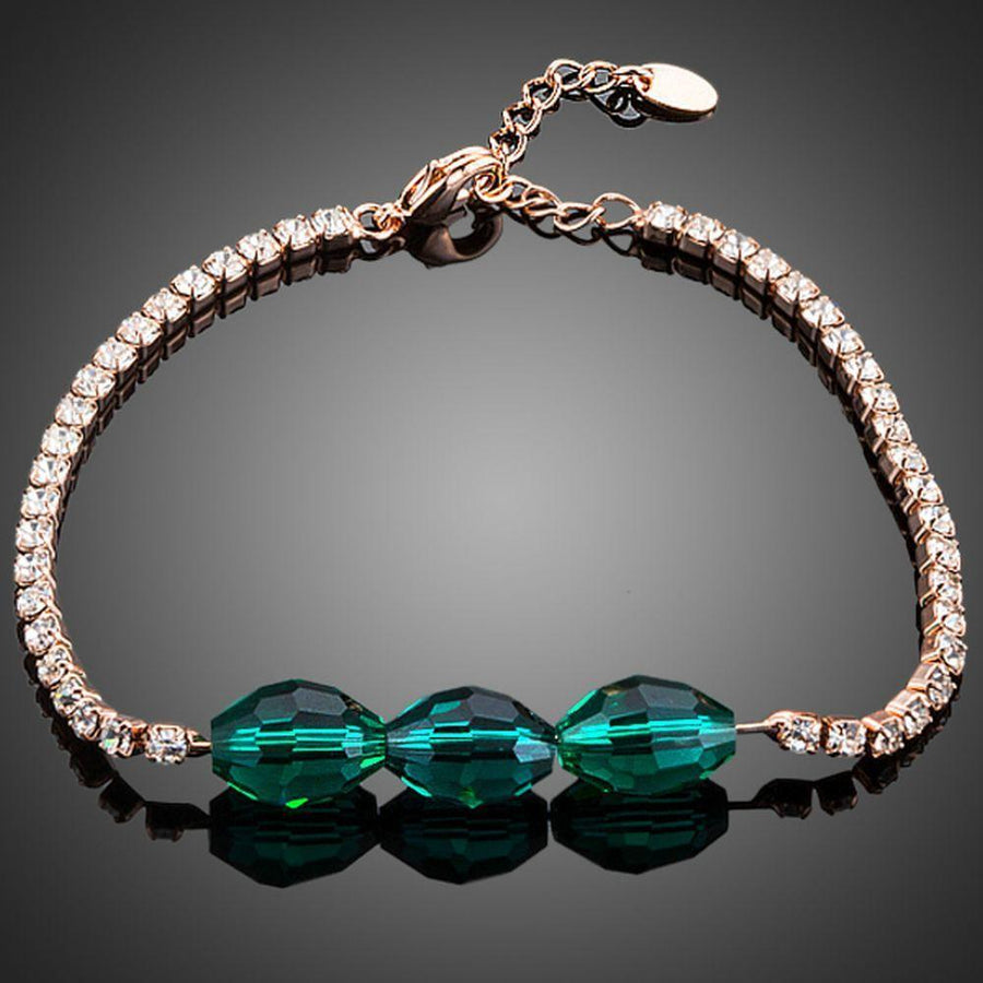 KHAISTA green crystal link chain bracelet on white background