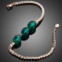 Close up detail of KHAISTA green crystal link chain bracelet