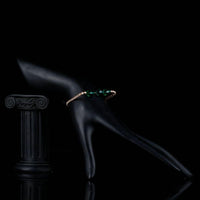 Side angle view of KHAISTA green crystal link chain bracelet