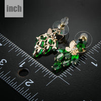 green CZ butterfly drop earrings detail view by KHAISTA
