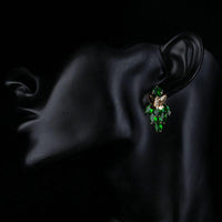 Close up of KHAISTA green CZ butterfly drop earrings